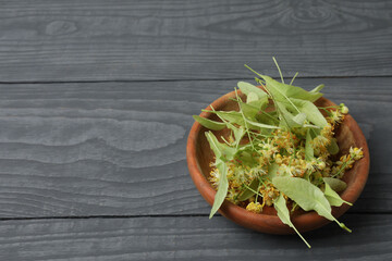 cup of herbal tea with linden flowers on wooden background
