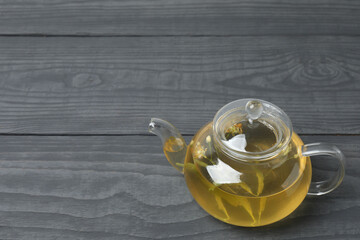 cup of herbal tea with linden flowers on wooden background