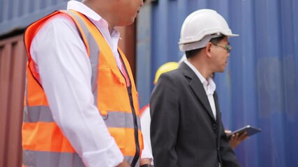 Logistics warehouse supervisor talking with team engineer inspecting container box at terminal, warehouse distribution, freight cargo shipping, delivery business. - Powered by Adobe