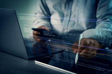 Programming code on representing person working laptop with digital code and tablet, using stylus,...