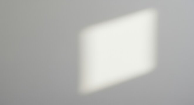 White light shadow projection on gray wall background. Minimal clean geometric surface. Natural sunlight window reflection. Interior design architecture banner horizontal copy space