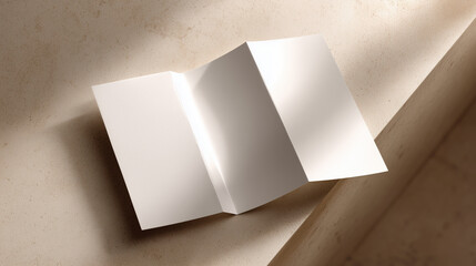 mockup photo of an tri-folded brochure (folded in three) laying flat on a light beige, smooth-textured coffee table
