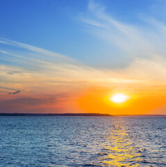 red dramatic sunset over a calm wide lake,  beautiful natural evening water scene