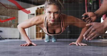 Trainer starting timer while trainee performing push-ups on rubber mat with red metric lines rising - Powered by Adobe