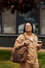 University teacher enjoys a coffee break while walking on campus in the afternoon sun