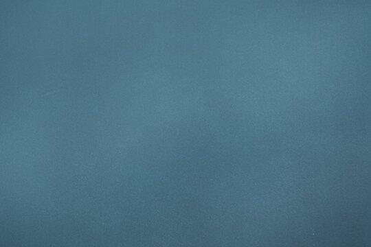 Abstract flat design illustration is showing uniform blue field with subtle grainy texture