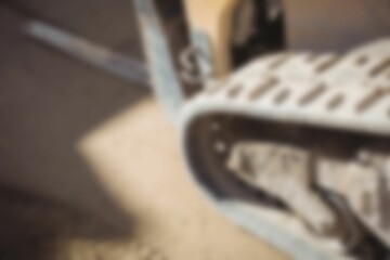 Defocussed image of forklift truck caterpillar tyre track, with copy space