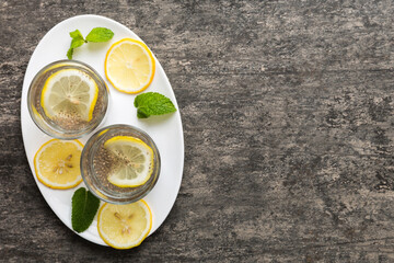 Healthy breakfast or morning with chia seeds lemon and mint on table background, vegetarian food,...