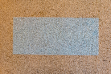 Unsung textures reveal hidden stories on a weathered wall in a quiet urban setting, offering a...