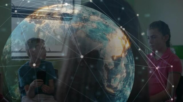 Boy tapping phone and teacher using laptop launching rotating globe with network overlay for lesson
