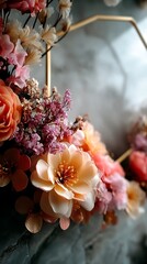 Elegant Floral Arrangement with Geometric Gold Frame: A Symphony of Peach and Pink Blossoms.