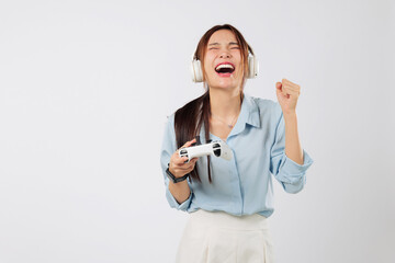 Game play moment of a teen young woman with headphones, cheering in joy after tough game level...