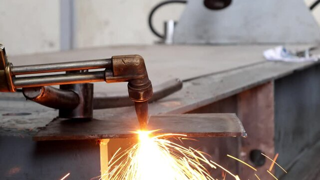 Metal cutting with acetylene and oxygen gas torch,  separated from each other. With a red flame off the brass cutting head And sparks of fire fell out 