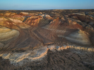 Aerial view over Aktumsik's colorful sediment hills and deep desert ravines