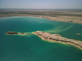 Aerial: elongated desert island in Kuimazar Reservoir, Uzbekistan