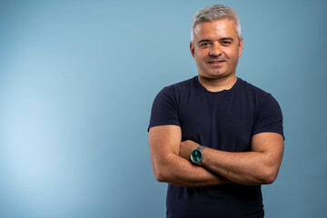 Caucasian handsome man isolated on blue background keeping the arms crossed in frontal position