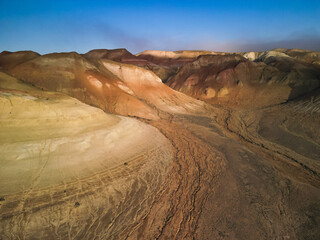 Aerial view tracing deep ravines and dramatic Aktumsuk landforms in Uzbekistan