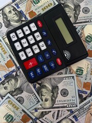 Calculator placed on US dollar bills representing finance accounting banking investment and...