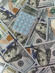 Fototapeta premium Calculator on US dollar bills symbolizing loans debt financial crisis and economic instability