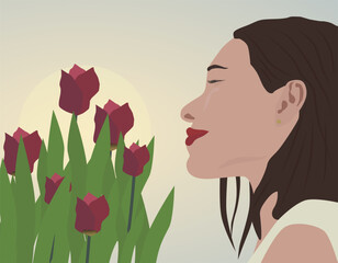 A woman enjoys the aroma of tulips against the backdrop of the sun. The image conveys a feeling of spring, harmony, peace and feminine tenderness.