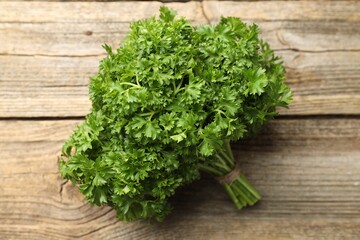 Bunch of fresh parsley on wooden table, closeup