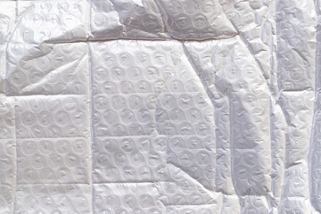 white packaging film with folds and wrinkles, abstract background