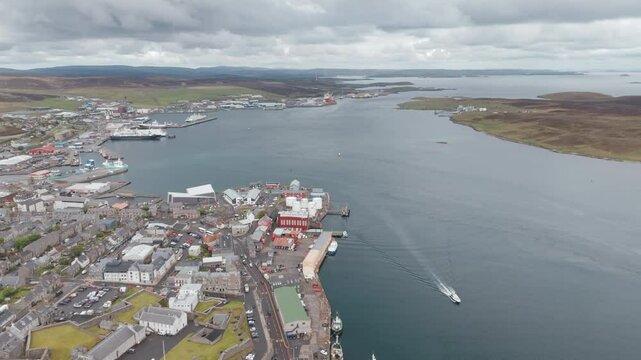 An aerial shot of the harbour town of Lerwick, Shetland in Scotland, sweeping over the port area.