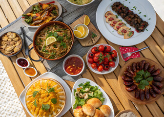 A festive table filled with a variety of dishes from around the world: from Italian pasta and Japanese sushi to Mexican