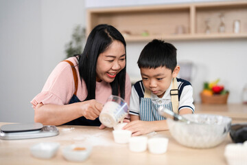 Family Baking Experience. A mother and son preparing treats together, sharing smiles in the kitchen.