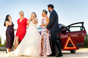 Bride and friends reacting to car trouble on wedding day
