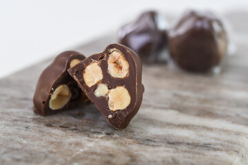 Decadent Chocolate Hazelnut Clusters on Marble with chopped hazelnuts embedded within the chocolate...