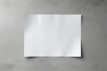 A white A1 size poster mockup on a on a raw concrete background with soft shadows