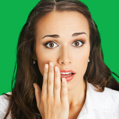 Wow! Face portrait - expressive surprised, astonished shocked businesswoman keep hand over mouth. Amazed corporate business woman cover mouth, isolated green background. Square image