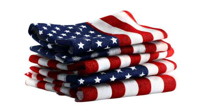 A stack of folded american flag patterned cloths on a black background in a close up shot view