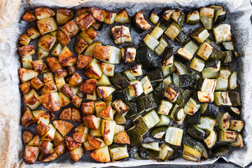 roasted cubed baby potatoes and zucchini on oven tray