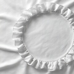 A white circular pillowcase with a ruffled edge, rests on smooth white fabric