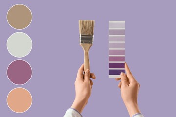Hands with violet paint palette swatches and brush on lilac background. Different color patterns
