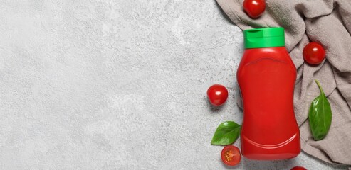 Tasty ketchup, tomatoes and basil on grey background with space for text