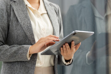 Digital Transformation. Businesswoman using tablet for work in modern office.
