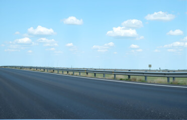 Fototapeta premium Highway Under Blue Sky and White Clouds