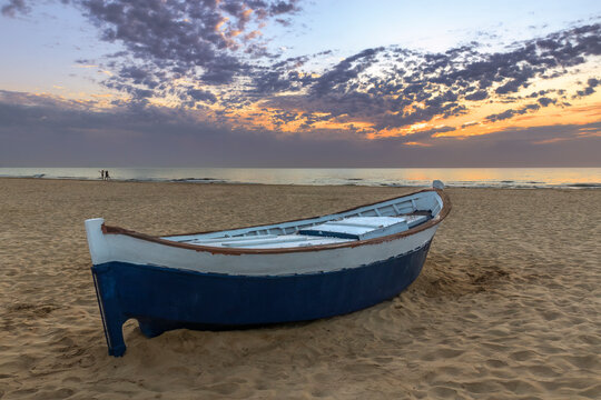 barca varada al amanecer en la playa de la Malvarrosa, Valencia, Espa&ntilde;a