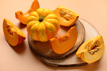 Wooden board with fresh pumpkins on brown background