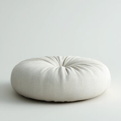 Obraz premium Off-white, round floor cushion; plump, gathered fabric; simple, minimalist design; sits on a light background