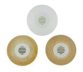 Side-by-side on a transparent background, two heavily soiled and worn water filters are positioned next to a gleaming, new white filter