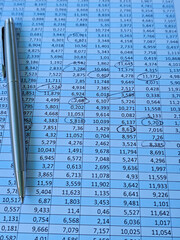 Data sheet with calculations and a silver pen resting