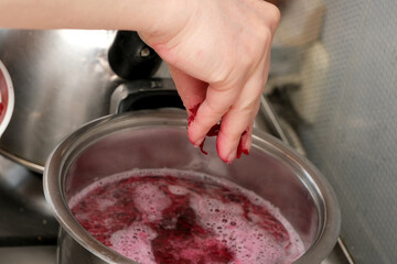 Creating vibrant homemade jam in a cozy kitchen setting