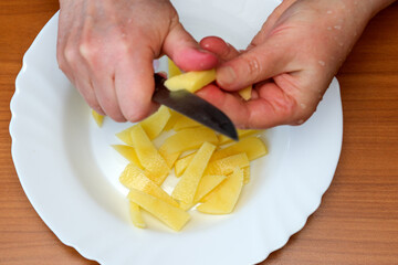 Mastering the art of peeling potatoes in a cozy kitchen setting