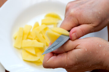 Slicing fresh potatoes for a delicious culinary creation