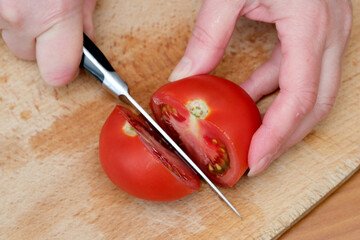 Slicing ripe tomatoes in a cozy kitchen on a sunny afternoon