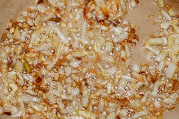 Crispy onions sizzling in golden oil create a mouthwatering aroma